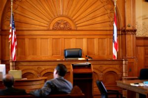 A person sitting in one of the courtrooms used by the Law Offices of Jerod Gunsberg in Los Angeles