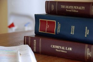 A stack of law books covering law practices held at the Law Offices of Jerod Gunsberg in Los Angeles, CA